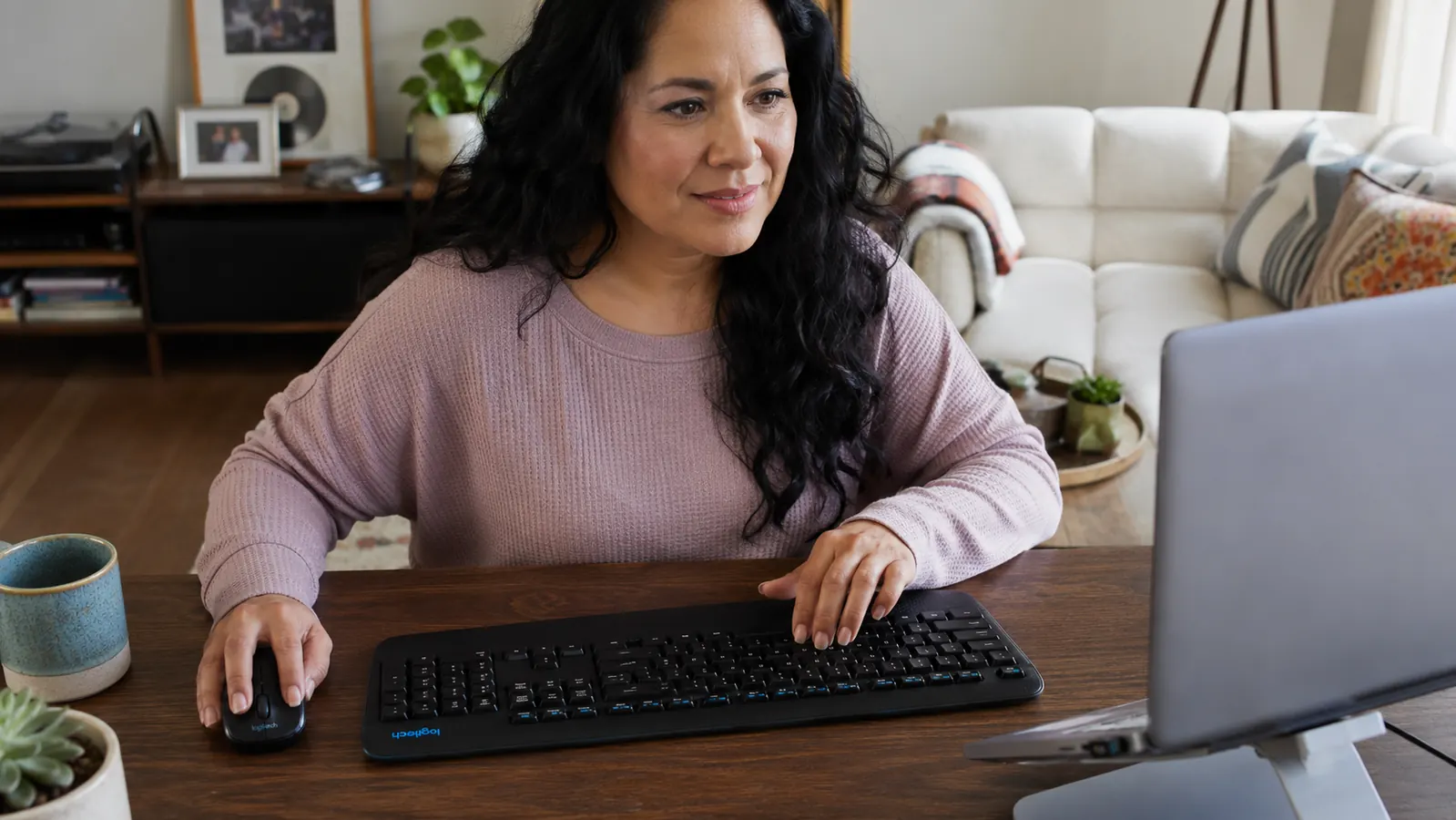 Logitech MK345 USB receiver plugged into a laptop port showing the single dongle wireless setup